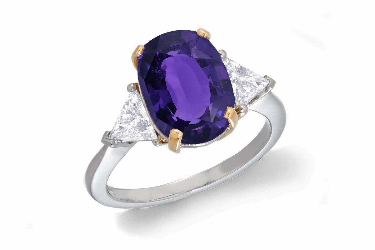 685 custom made unique oval purple sapphire center stone and trillion diamond accent three stone engagement ring