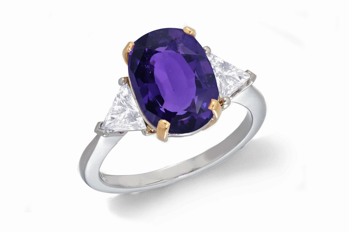 685 custom made unique oval purple sapphire center stone and trillion diamond accent three stone engagement ring