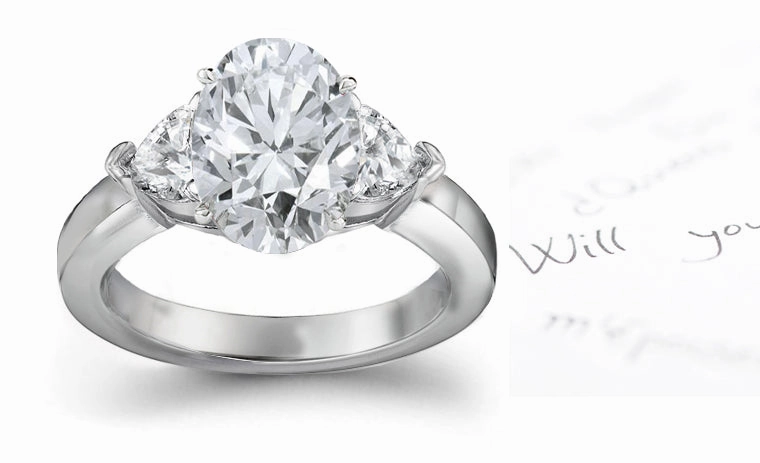engagement ring with oval diamond center and side heart diamonds